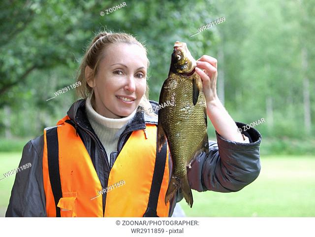 young woman the fisherman with caught the bream