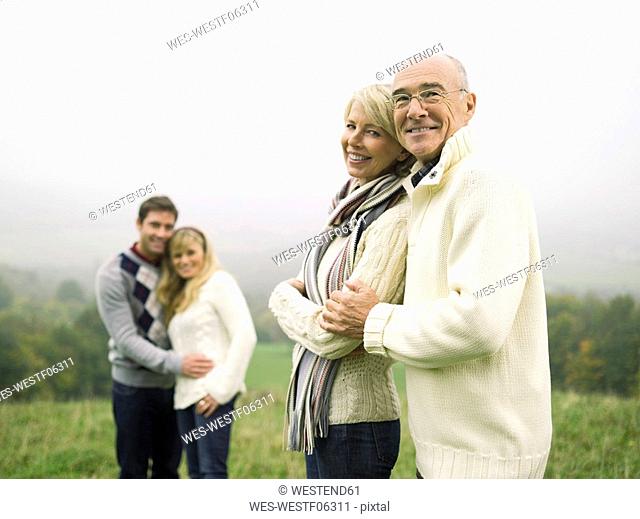 Germany, Baden-Württemberg, Swabian mountains, Smiling couples hugging each other