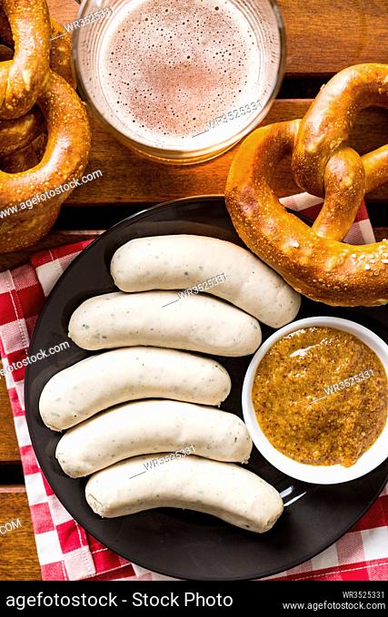 The bavarian weisswurst, pretzel and mustard. Top view