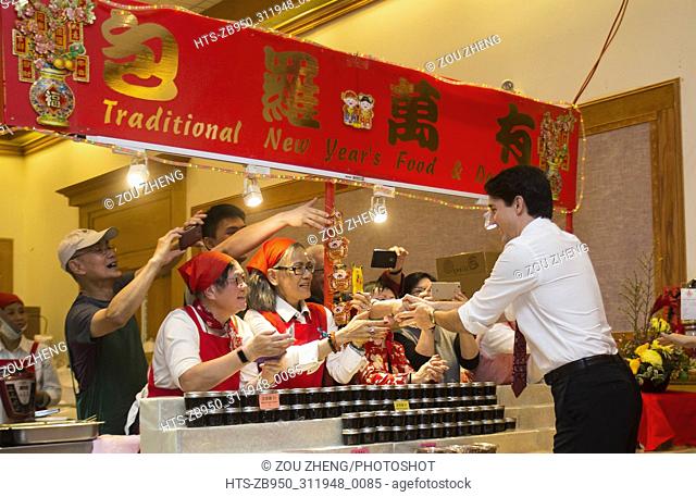 (180216) -- MISSISSAUGA (CANADA), Feb. 16, 2018 () -- Canadian Prime Minister Justin Trudeau (R) shakes hands with people at a Chinese New Year Market during...