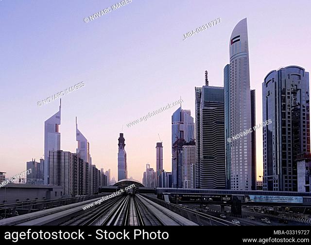 Metro next to Sheikh Zayed Road at sunset, Dubai, United Arab Emirates