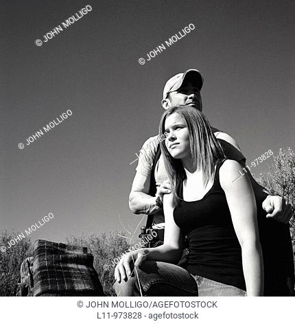 Man and woman with backpack; rural