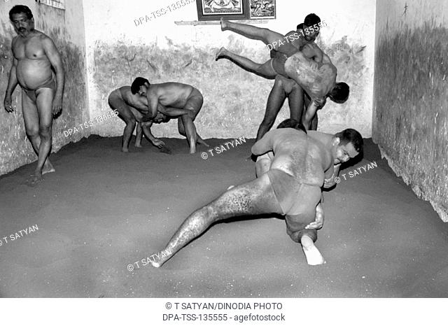 Men practicing Nada kushti  ; traditional Indian wrestling ; Mysore ; Karnataka ; India