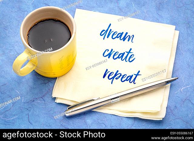 dream, create, repeat inspirational text - handwriting on a napkin with a cup of coffee