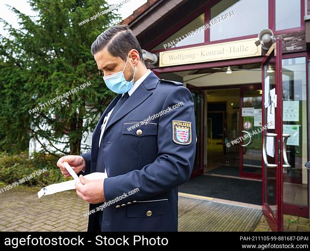 05 November 2021, Hessen, Büdingen: Police press officer Tobias Kremp stands in front of the Wolfgang Konrad Hall in the Lorbach district this afternoon with a...