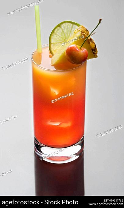 Mai Tai cocktail on a grey background with reflection