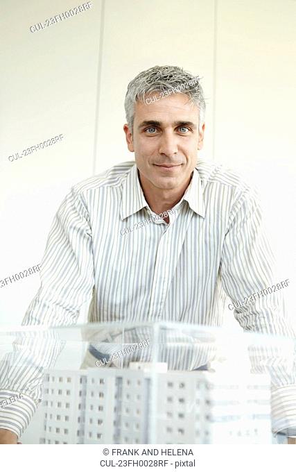 Man standing next to architectural model