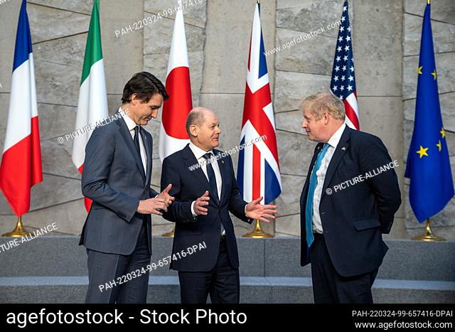 24 March 2022, Belgium, Brüssel: German Chancellor Olaf Scholz (M, SPD), talks with Justin Trudeau (l), Prime Minister of Canada, and Boris Johnson