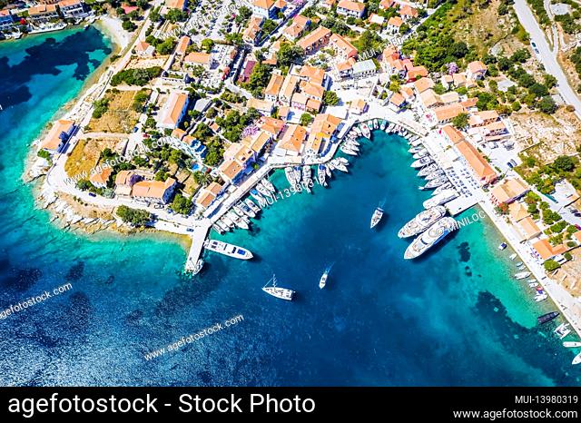 Beautiful Fiscardo village at Kefalonia or Cephalonia Island. Yachting bay and a ferry ship in the port