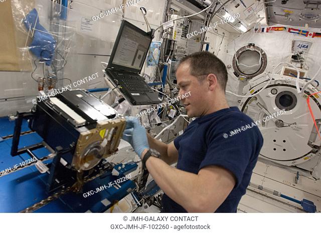NASA astronaut Tom Marshburn, Expedition 35 flight engineer, works on the Marangoni Inside core cleaning in the Kibo Japanese Experiment Module onboard the...