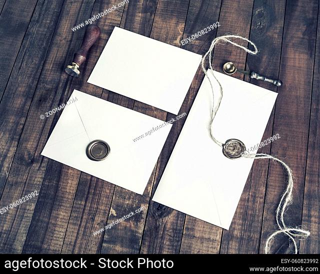 Blank envelopes and retro stationery on wooden background