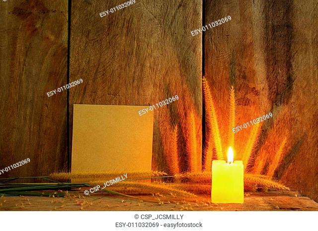 Still life with Foxtail grass, burning light and notepad on wooden background