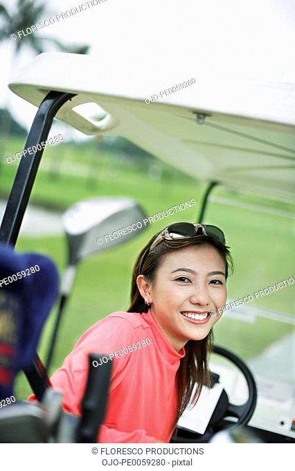 Woman in a golf cart