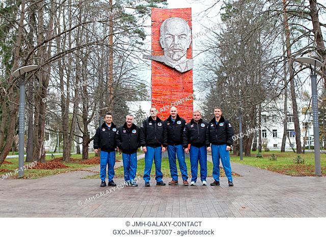 With the statue of Vladimir Lenin serving as a backdrop, the Expedition 38 prime and backup crew members pose for pictures October 26 at the Gagarin Cosmonaut...