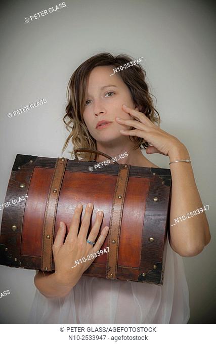 Young woman holding a wooden case