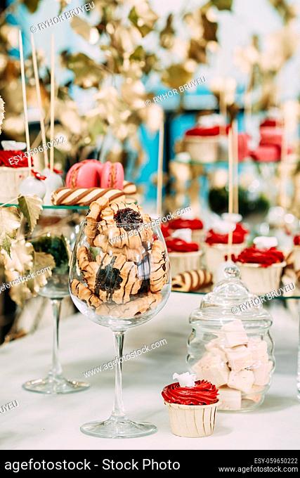 Dessert Sweet Tasty Cupcakes, Cookies In Candy Bar On Table. Delicious Sweet Buffet. Wedding Decorations