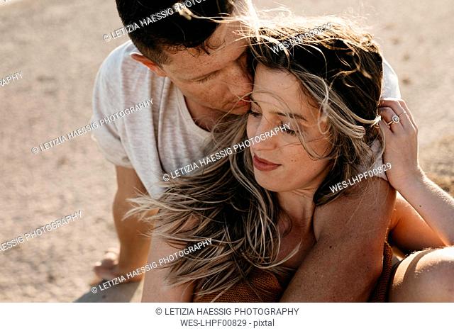 Affectionate young couple on the beach