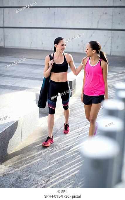 MODEL RELEASED. Two young women in sports clothing, smiling