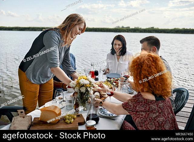 Friends having dinner at a lake