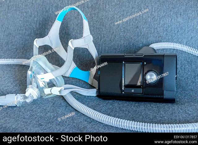 CPAP mask with a full face mask cpap machine against obstructive sleep apnea helps patients as respirator mask and headgear clip for breathing medication in...