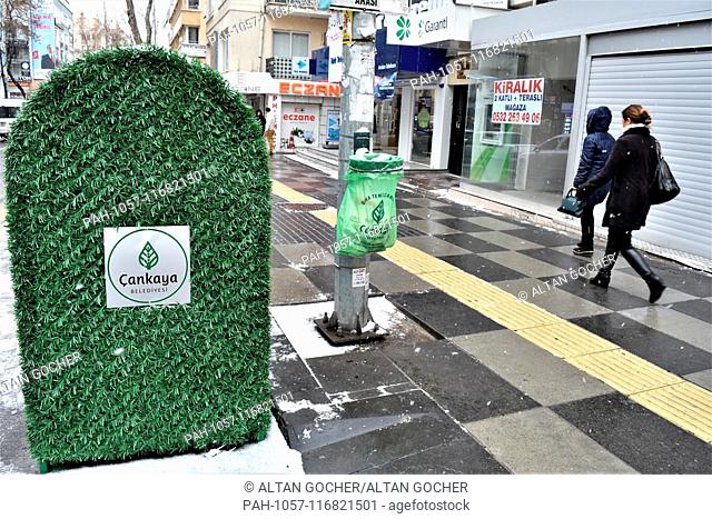 17 January 2019, Turkey, Ankara: People walk past a garbage can with a green eco-friendly design placed next to a sidewalk by the main opposition Republican...