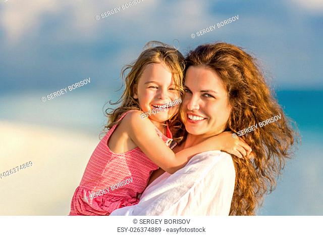 Portrait of mother and little daughter on the beach
