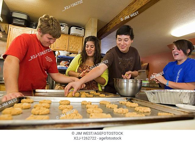 Alamosa, Colorado - High school students from First United Methodist Church in Chula Vista, California make cookies at a homeless shelter operated by La Puente...
