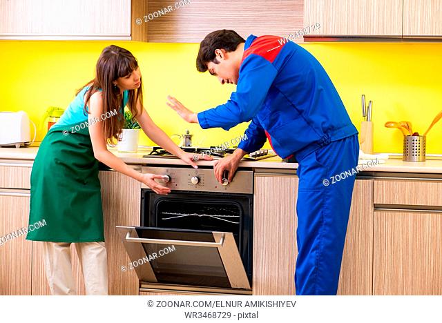 Woman with contractor at kitchen discussing repair