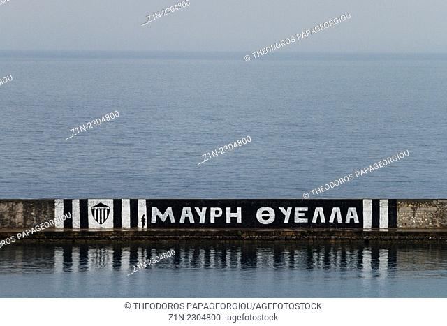 Footbal slogan (Black Storm) painted on the jetty of Kalamata's harbour. Messenia, Peloponnese, Greece