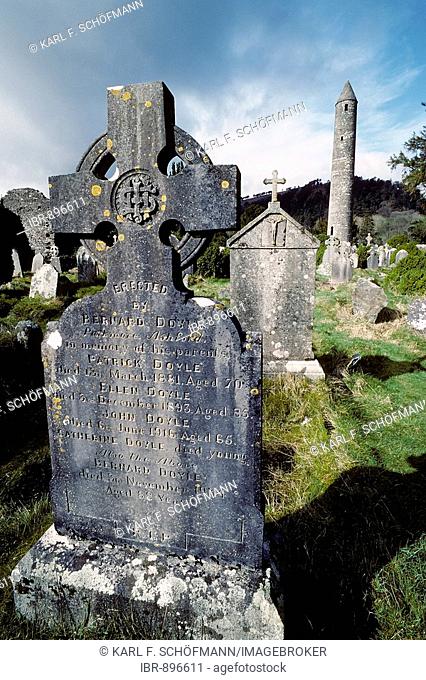 Glendalough, monastery ruins, old gravestone with celtic cross, round tower, County Wicklow, Ireland, Europe