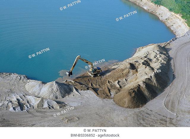 aerial view to excavator on quarry pondside, Belgium