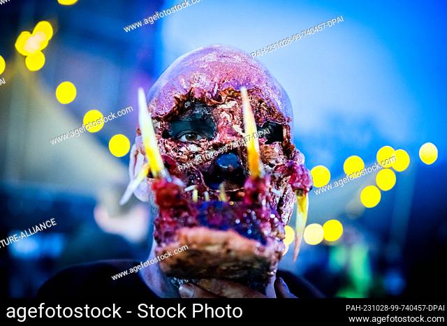 28 October 2023, Berlin: Sebastian wears a self-made mask before the start of the Halloween Run Berlin 2023. The course leads through the Volkspark...