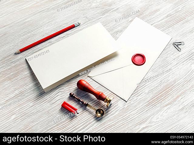 Vintage stationery and blank envelope on light wooden background. Template for graphic designers portfolios