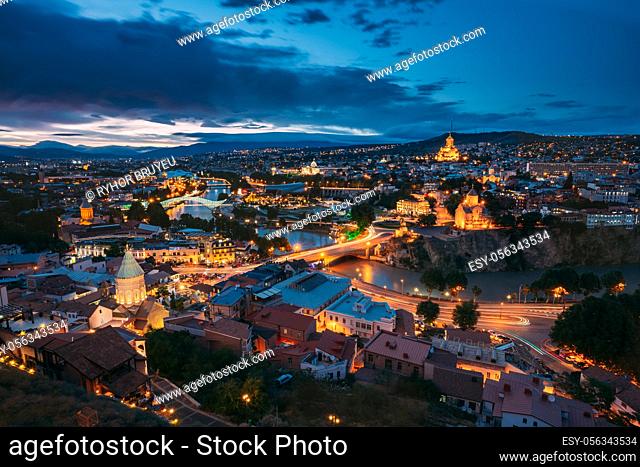Tbilisi, Georgia. Evening Night View Of Georgian Capital Skyline. Scenic Top View Of Summer Evening Cityscape Of Tbilisi