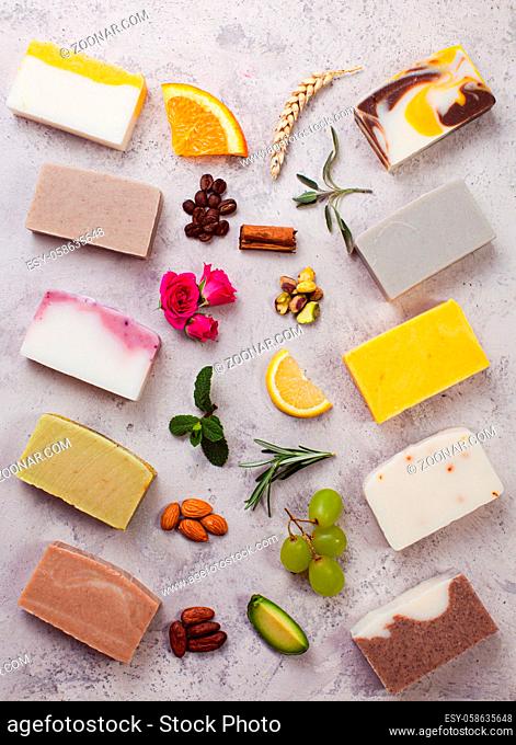 Collection of organic soap with demonstration of its natural components. Fruits, greens, nuts, flowers as ingredients of natural cosmetics