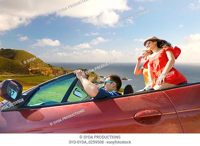 friends driving in convertible car over big sur