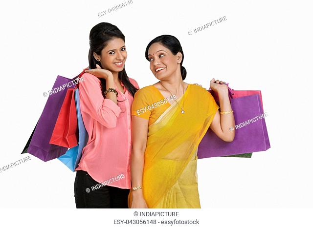 Mother and daughter with shopping bags