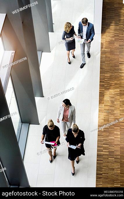 Business people walking in modern office building