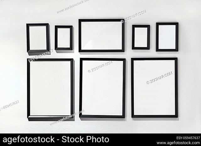 Set of empty picture frames on a wall in different sizes