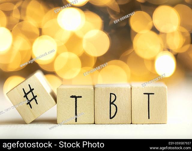 Hashtag TBT throwback Thursday written with wooden cubes with shiny bokeh background, social media concept colorful