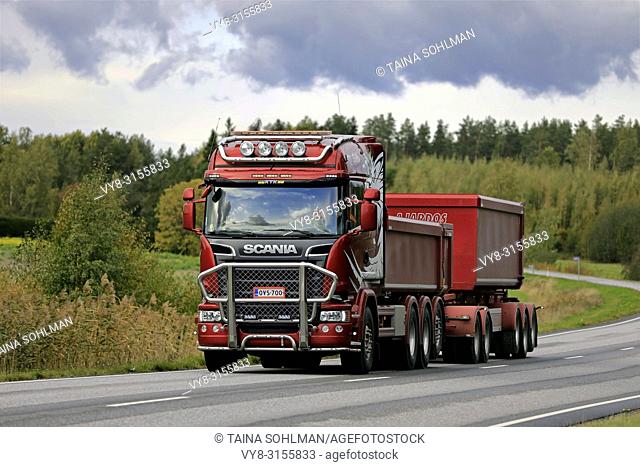 Salo, Finland - September 28, 2018: Red Scania R730 truck and gravel trailer for limestone haul of R Aalto on the road in autumn in South of Finland
