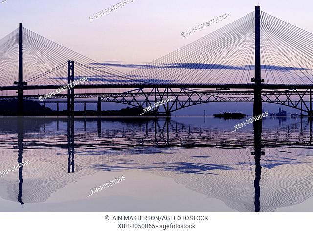Sunrise view of the three major bridges crossing the Firth of Forth at South Queensferry; Queensferry Crossing, North Road Bridge and the Forth Bridge ( rail)