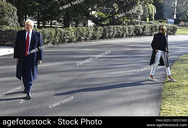United States President Donald J. Trump responds to a question from the press as first lady Melania Trump walks past as they depart the White House for a trip...