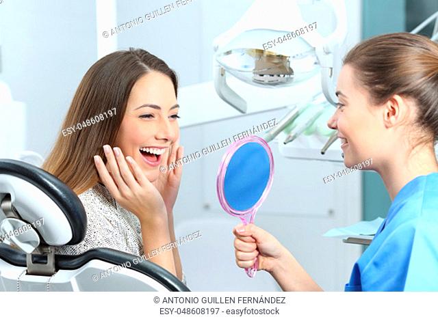 Happy dentist patient checking whitening results