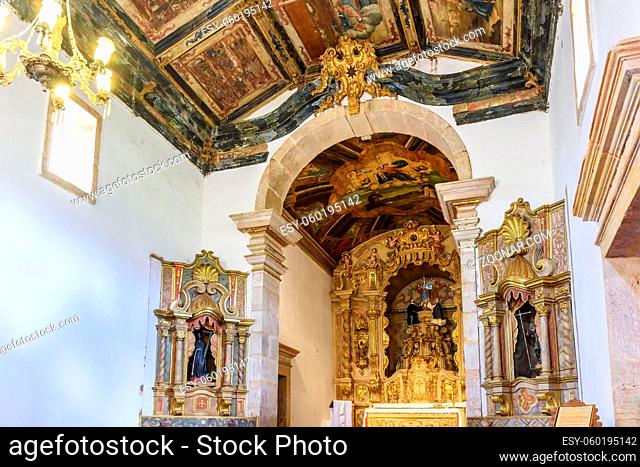 Interior and altar of a brazilian historic ancient church from the 18th century in baroque architecture with details of the walls in gold leaf in the city of...