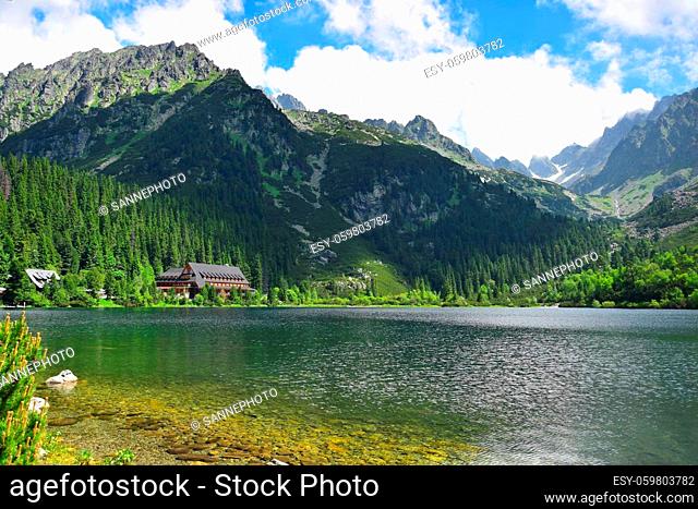 The beautiful lake Popradske pleso, surrounded by the Tatra mountains, and a mountain hotel. Slovakia. Image taken from public ground