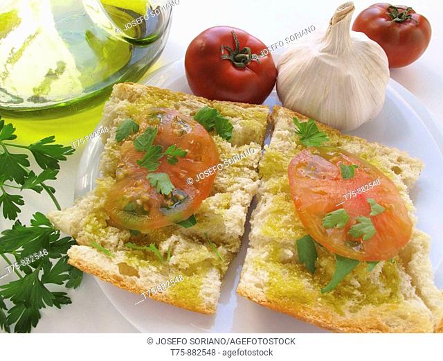Toasted bread with olive oil, tomatoes, garlic, parsley and salt
