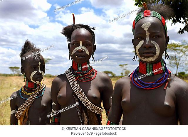 Three young girls of Hamar tribe looking at the camera, Ethiopia, East Africa
