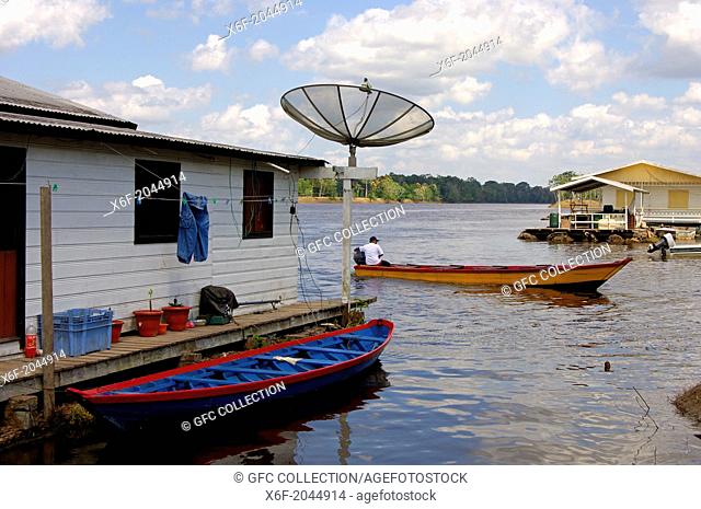 Houseboat with satellite dish at the Rio Negro, Amazonia Brazil