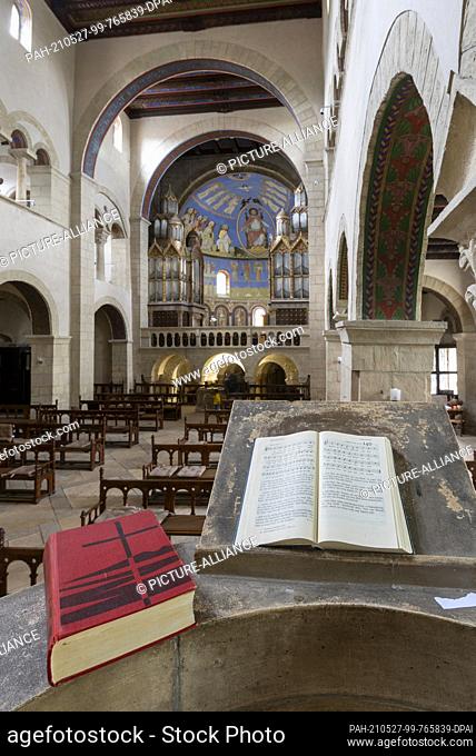 22 May 2021, Saxony-Anhalt, Gernrode: Hymnals lie on the pulpit of the collegiate church of St. Cyriakus in Gernrode. The church is one of the most important...